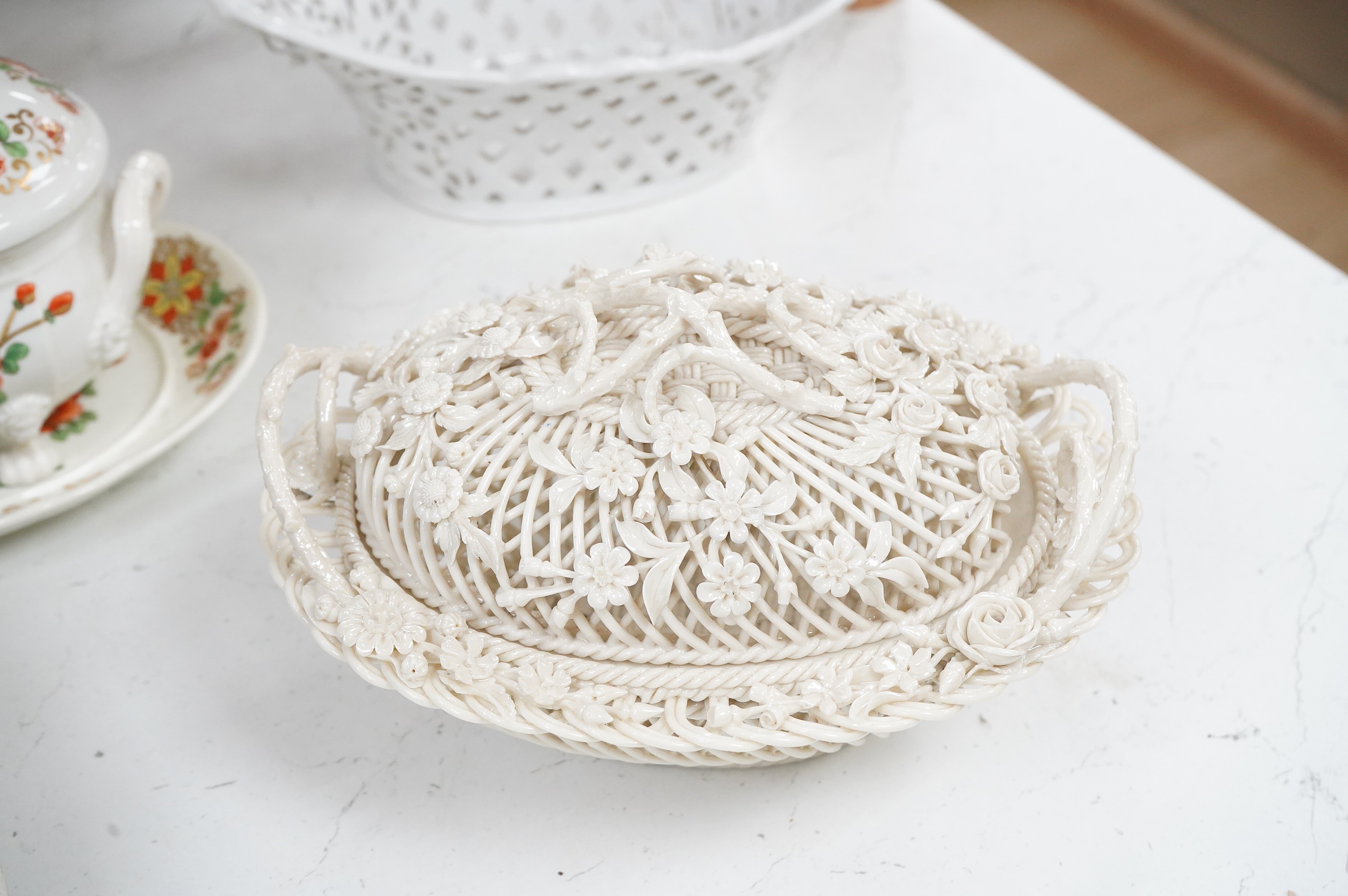 A 19th century Derby tureen and cover, a pair of Royal Worcester blush vase-26cm high, a Belleek basket and cover, a Wedgwood blue Jasperware cheese dish and associated cover, two continental baskets and vase. (7).